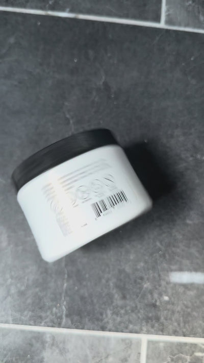 Video: hands hold a Coconut Baby jar with the older black lid, open it to show the solid white oil, then a smiling baby